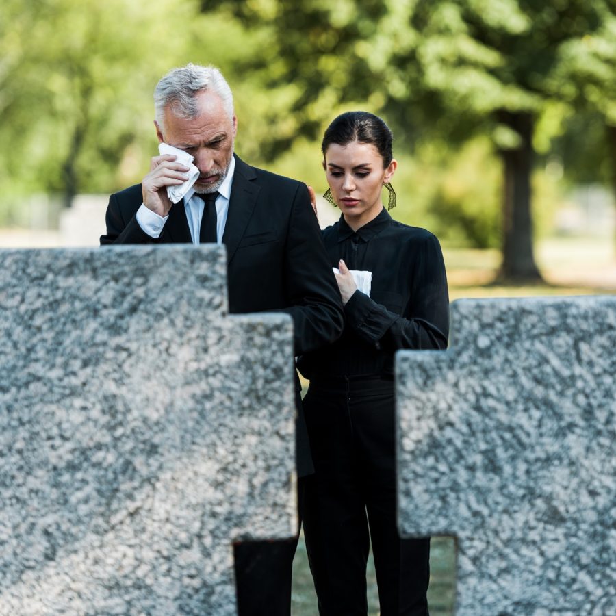 selective-focus-of-upset-man-crying-near-woman-on-funeral.jpg